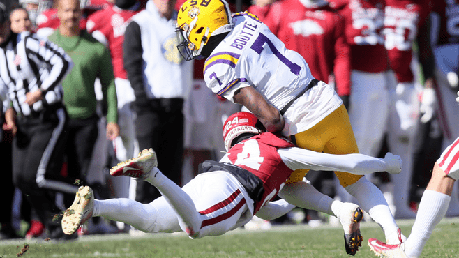  LSU wide receiver and former Westgate High star Kayshon Boutte (7) is tackled by Arkansas Razorbacks defensive back Quincey McAdoo (24) at Donald W. Reynolds Razorback Stadium earlier this season. -- Photo by Nelson Chenault-USA TODAY Sports/Reuters
