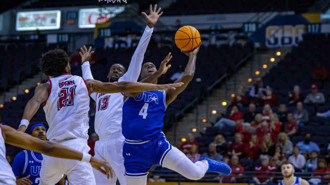 UT Arlington's David Azore (No. 4) tries to drive to the basket while being defended by Louisiana's Jordan Brown (No. 21) and Greg Williams Jr. (No. 13) during Thursday's game at the Sun Belt Conference Tournament. -- Photo courtesy of Sun Belt Conference