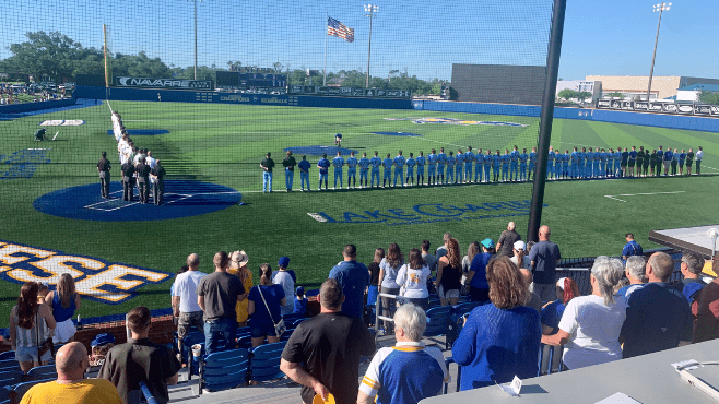 The Southeastern Lions and McNeese Cowboys stand down the foul lines for the playing of the national anthem before Friday night's game at Joe Miller Ballpark. -- Photo by Raymond Partsch III